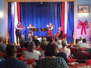 a group of people sitting in front of a curtain