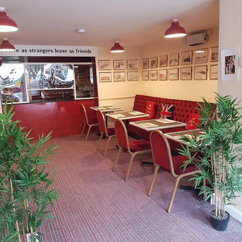 a living room filled with furniture and vase of flowers on a table