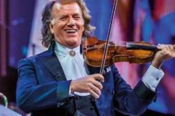 Andre Rieu holding a guitar