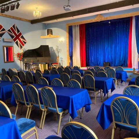 a room filled with furniture and a blue chair